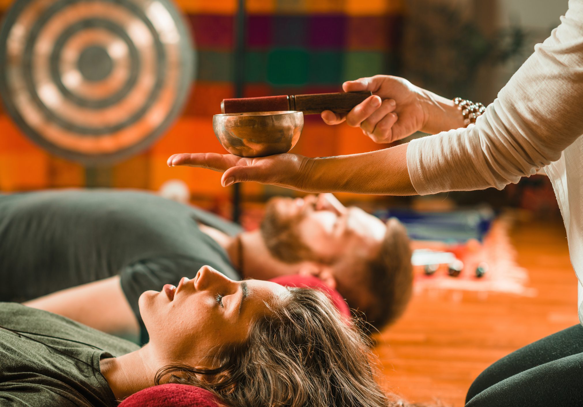 Therapist Playing Rin Gong Over Couple While Performing Music Therapy At Spa